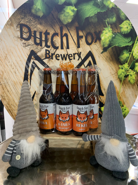 Drie verschillende Dutch Fox bieren voor een ronde achtergrond met hops en twee grijze kabouters.
