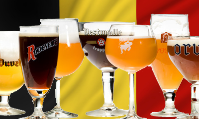 Assortiment Belgische bieren in verschillende glazen voor een Belgische vlag.
