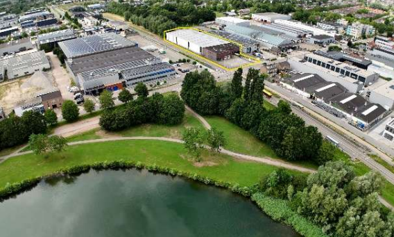 Luchtfoto van bedrijventerrein Strijkviertel met groen park en water op de voorgrond.