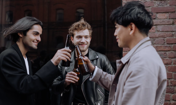 Drie mannen proosten met bier